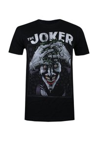 Black cotton t-shirt featuring a graphic of a Joker character with green hair and exaggerated facial features, printed in white, red, and gray.