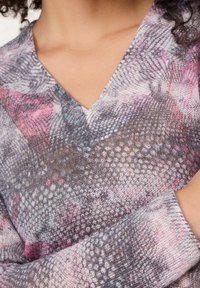 V-neck sweater with a soft knit texture, featuring a multicolored pattern in gray, pink, and blue tones, and long sleeves with ribbed cuffs.