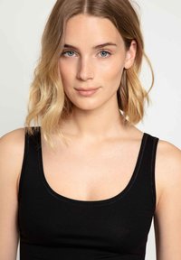 Black sleeveless top with a scoop neckline, made of a smooth fabric. The design features clean, simple lines and a fitted silhouette.
