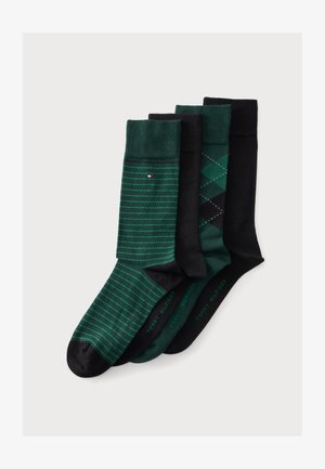 Quatre paires de chaussettes Tommy Hilfiger en vert et noir, avec des rayures, motif losanges, couleurs unies et logo de la marque sur fond blanc.