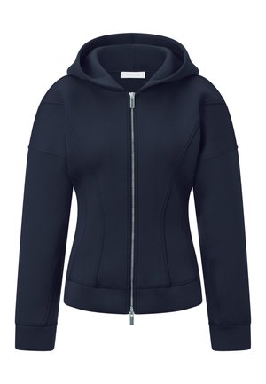 Sweatshirt à capuche zippé bleu marine avec un design ajusté, une fermeture éclair à l'avant, des poignets côtelés et des coutures à plat pour un détail structuré.