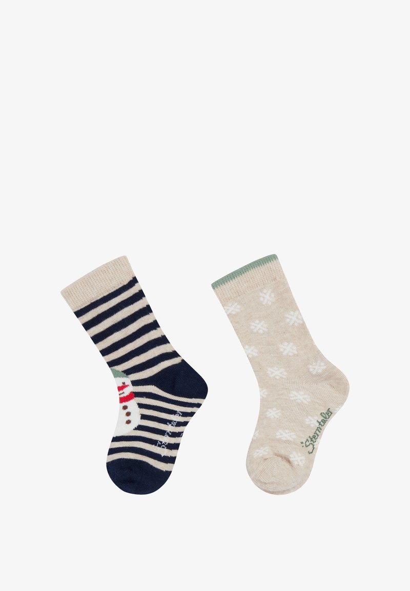 Two children's socks: one navy and beige striped with a snowman, the other beige with white snowflakes and green trim.