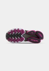Shoe sole with a pattern of pink and black rubber lugs. Features a white midsole with a grid texture and additional black accents.