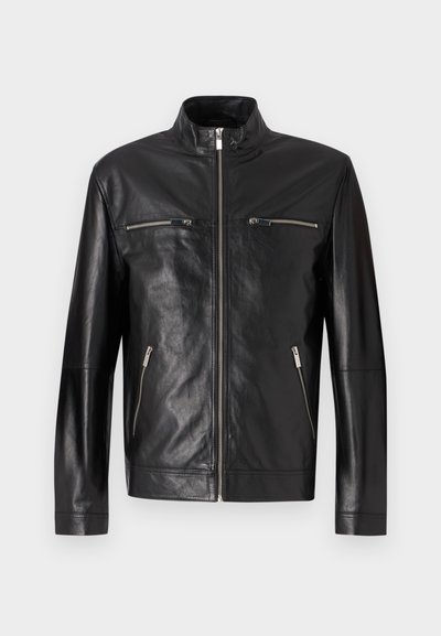 Black leather jacket with a high collar, front zipper, and two zippered chest pockets. Smooth texture with minimal stitching details.