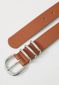 Brown leather belt with a textured finish, featuring three metallic silver accents and a rectangular buckle. Ends are rounded.