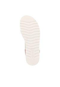 Semelle de chaussure en caoutchouc blanc avec une texture ondulée et un logo en relief. Partie supérieure de couleur beige clair visible avec une finition lisse. Le design global est fonctionnel.