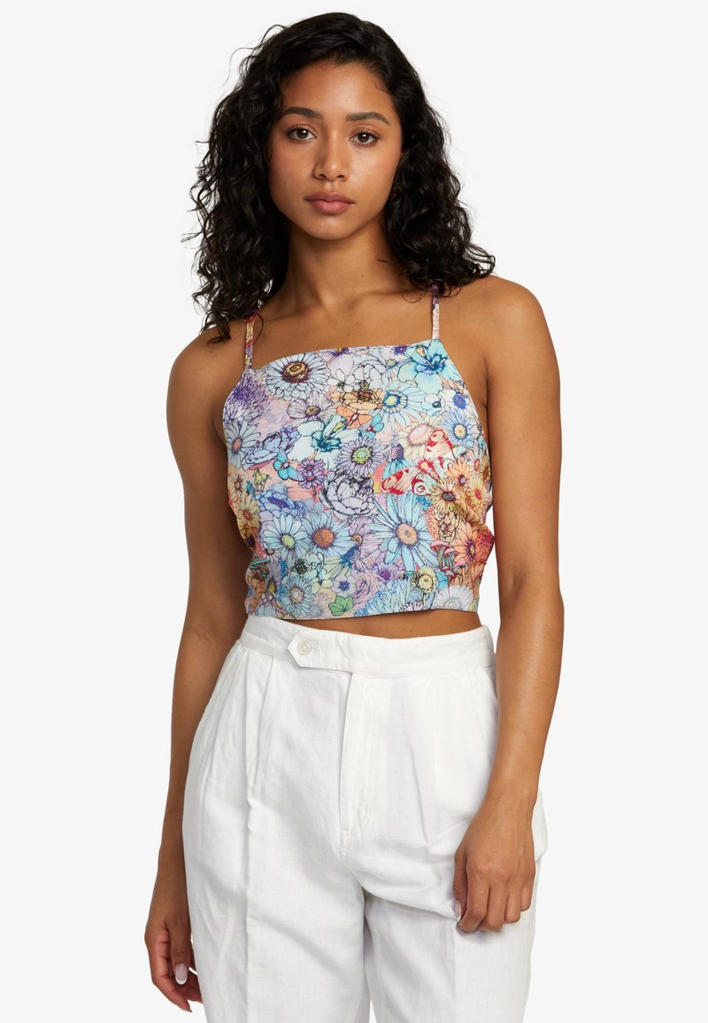 Cropped tank top with a colorful floral pattern, featuring thin straps and a lightweight fabric. Worn with white high-waisted pants.