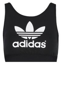 Cropped top atletico nero realizzato in tessuto elasticizzato. Presenta un logo Adidas bianco e tre strisce bianche disposte in un motivo a foglia sulla parte frontale.
