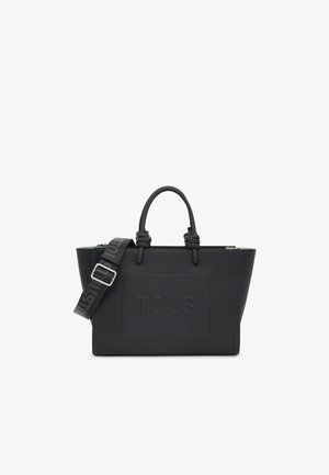 Borsa tote nera con il logo "TOUS" in rilievo. Presenta manici doppi, tracolla regolabile, forma strutturata e materiale texturizzato.