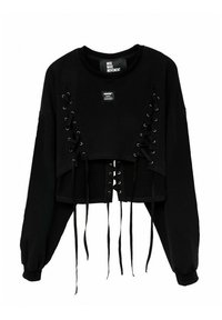 Sudadera negra corta con mangas largas, con detalles de lazada lateral en cuerda negra y un escote redondo. Tejido texturizado con etiqueta.
