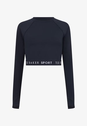 Marineblaues Crop-Top mit langen Ärmeln aus glattem Stoff. Verfügt über einen gerundeten Halsausschnitt, Raglanärmel und einen Bund mit dem Aufdruck "TED BAKER SPORT".