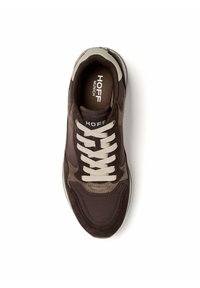 Brown and dark brown lace-up sneaker with white laces, suede and fabric panels, and "HOFF MUNICH" printed on the insole and tongue.