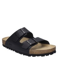 Sandal nera a due cinture con fibbie regolabili, soletta in sughero e suola in gomma testurizzata, con una parte superiore liscia e punta arrotondata.