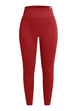 Rode geribde leggings met een hoge taille, aangesloten pasvorm en een gladde textuur. Geen opvallende patronen of hardware zichtbaar.