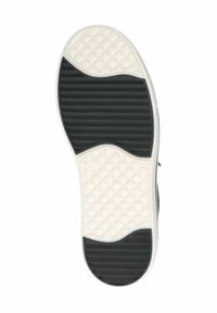 Semelle de sneaker en noir et blanc avec des motifs texturés : un design en nid d'abeille sur les zones blanches et des sections rainurées en noir pour la traction.