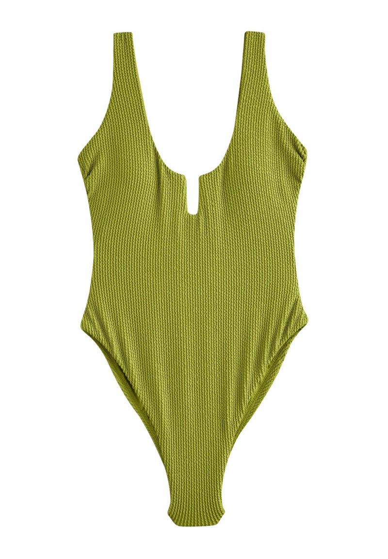 Maillot de bain une pièce vert à côtes avec un décolleté en V profond et un détail en découpe à l’avant. Doté de larges bretelles et d’un design de cuisses hautes.