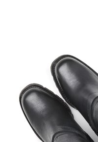 Black leather ankle boots with rounded toes and stitched edges, featuring a smooth texture and minimalistic design.