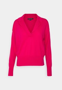 Pull-over rose avec col, manches longues et coupe décontractée. Tissu doux avec poignets et ourlet côtelés.