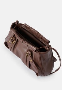 Brown leather handbag with a textured finish. Features a zippered opening, two side straps, and gold-tone hardware accents.
