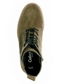 Olive green suede ankle boot with a rounded toe, featuring black laces, a side zipper, and stitched detailing along the sole.