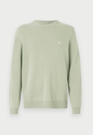 Light green crewneck sweater with long sleeves and a small white embroidered logo on the left chest.
