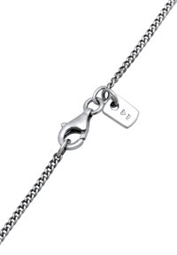 Sterling silver chain bracelet featuring a lobster clasp and a small rectangular tag with a stamped engraving, highlighting intricate links.