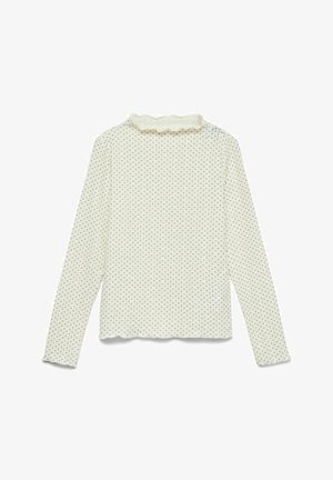 Dolga majica z dolgimi rokavi v krem barvi s črnimi pikami. Ima nabrano izrez in ravni rob. Izdelana iz mehke, lahke tkanine.