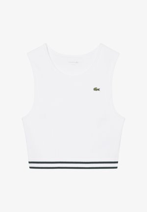 Top blanco sin mangas recortado con escote redondo, doble raya negra en el dobladillo y pequeño logo de cocodrilo verde de Lacoste en el pecho.