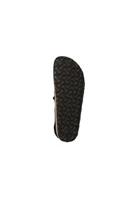 Semelle de chaussure en caoutchouc noir avec un motif texturé ondulé, présentant une base brun clair sur les bords. Conçue pour l'adhérence et la durabilité.