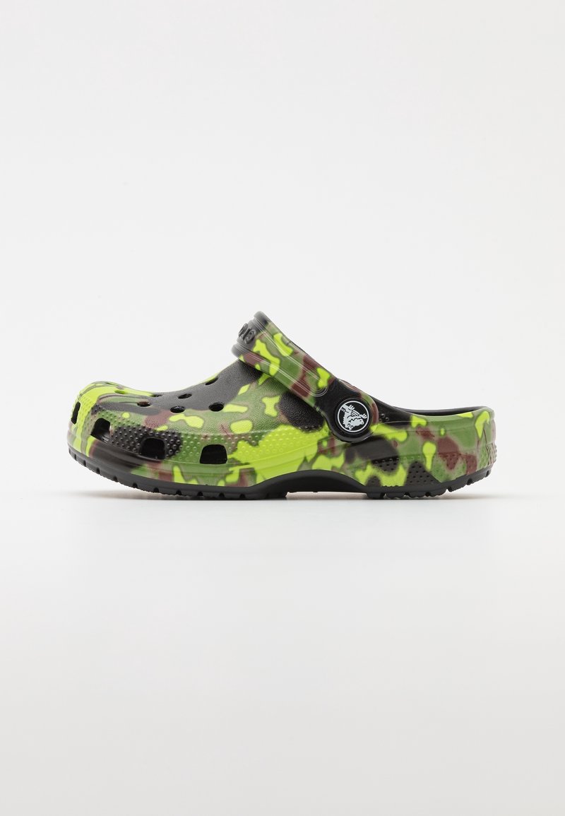 Croc-style footwear in green and black camouflage pattern, made of lightweight material, with ventilation holes and a back strap.