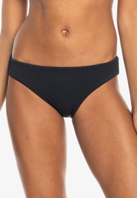 Black ribbed bikini bottom with a low rise and wide waistband, designed for comfort. Smooth texture, minimalist style with no visible accents.