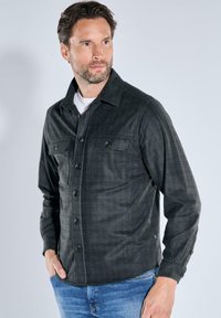Gray plaid shirt with a button-down front, two chest pockets, and a collar. Made from lightweight fabric, featuring long sleeves and a regular fit.