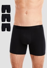 Black boxer briefs displayed in a three-pack, featuring a fitted design, elastic waistband with logo, and smooth fabric texture.