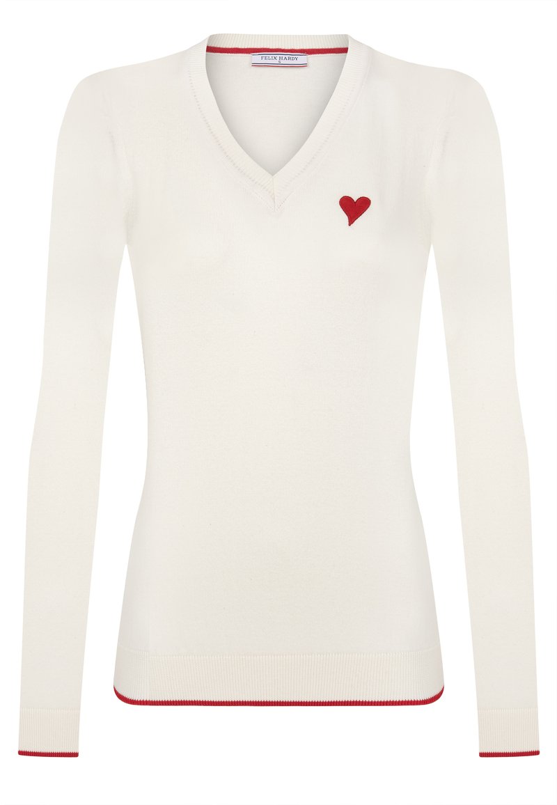 Crème kleurige gebreide trui met V-hals en lange mouwen, versierd met een klein rood hartje op de linkerborst en rode bies langs de boorden en de zoom.