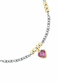 Bracciale in argento con accenti dorati, che presenta tre perline sferiche e un pendente in gemma rosa a forma di cuore.