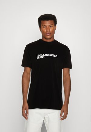 Black t-shirt with short sleeves, round neckline, and white "KARL LAGERFELD JEANS" logo on the front. Smooth cotton fabric.