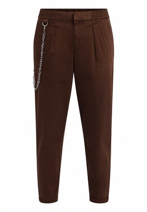 Brown, loose-fitting trousers with a smooth texture, featuring side pleats and a silver chain detail on the waistband.
