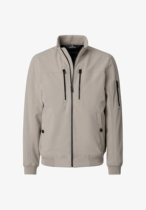 Lichtbeige jas met ritssluiting en opstaande kraag, twee verticale borstzakken met rits, twee zijzakken met knopen en één ritssluitingzak op de linker mouw.