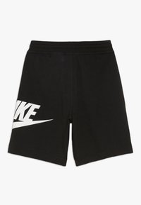Black shorts made of soft fabric featuring a prominent white Nike logo on the left side, with an elastic waistband for comfort.