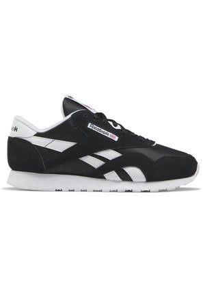 Black and white Reebok sneaker with white sole, Reebok logo on side and tongue, and black laces in side profile view.