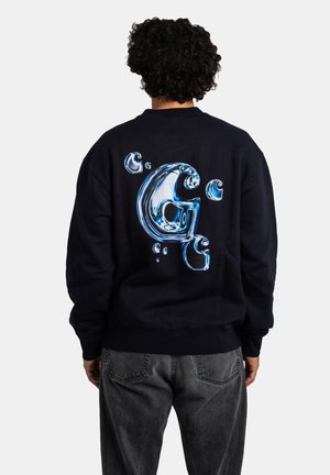 Navy sweatshirt featuring a large, glossy blue water droplet graphic centered on the back. Crew neck and ribbed cuffs complete the design.