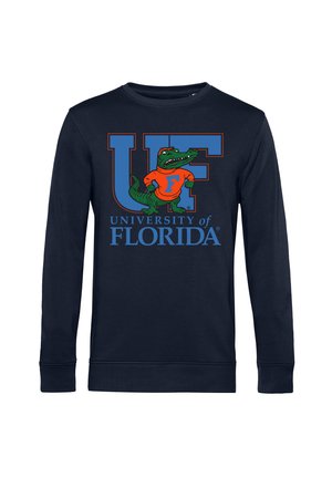 Námořnický svetr s nápisem "UF" v tučných modrých písmenech a aligátorem v oranžovém tričku, se nápisem "University of Florida" níže.