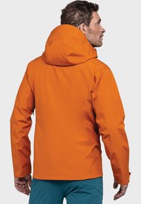 Orangene wasserdichte Jacke mit einer Kapuze, die über eine glatte Textur, verstellbare Träger und ein figurbetontes Design verfügt. Sie wirkt leicht und funktional.