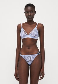 Light blue lace lingerie set featuring a bralette with floral patterns and thin straps, paired with matching thong underwear.