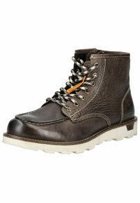 Bottines en cuir marron avec semelle en caoutchouc blanche, empeigne texturée, lacets noir et blanc, et détail de tag orange. Accents de double couture.