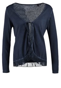 Cardigan à manches longues bleu marine avec col en V, devant froncé et ourlet à franges. Confectionné dans un tissu doux avec une finition légère et légèrement texturée.