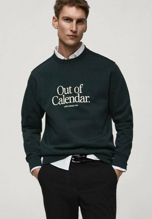 Dark green sweatshirt with ribbed cuffs and collar, featuring white text "Out of Calendar. UNPLANNED FUN" centered on the front.