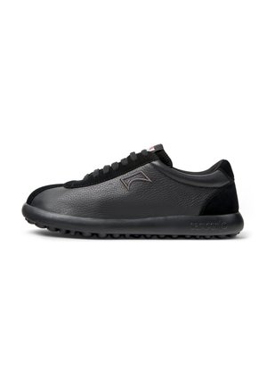 Black leather sneaker with textured surface, lacing, cushioned sole, and subtle branding. Features a rounded toe and black accents.