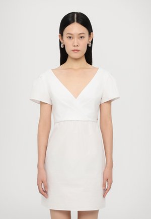 White cotton dress with short, puffed sleeves and a V-neckline. Fitted bodice with a gathered waist, falling above the knees.