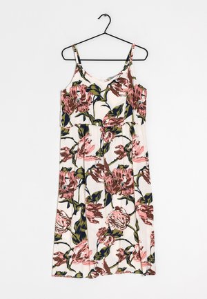 White sleeveless dress with pink and green large floral print hanging on black hanger against white background.